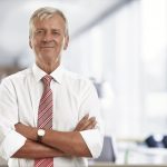 Confident older businessman in modern office