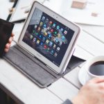 Tablet, smartphone, and coffee on wooden table