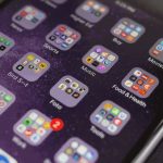Close-up smartphone home screen with app folders