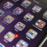 Smartphone home screen showing organized app folders