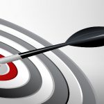 Arrow hitting red bullseye on target